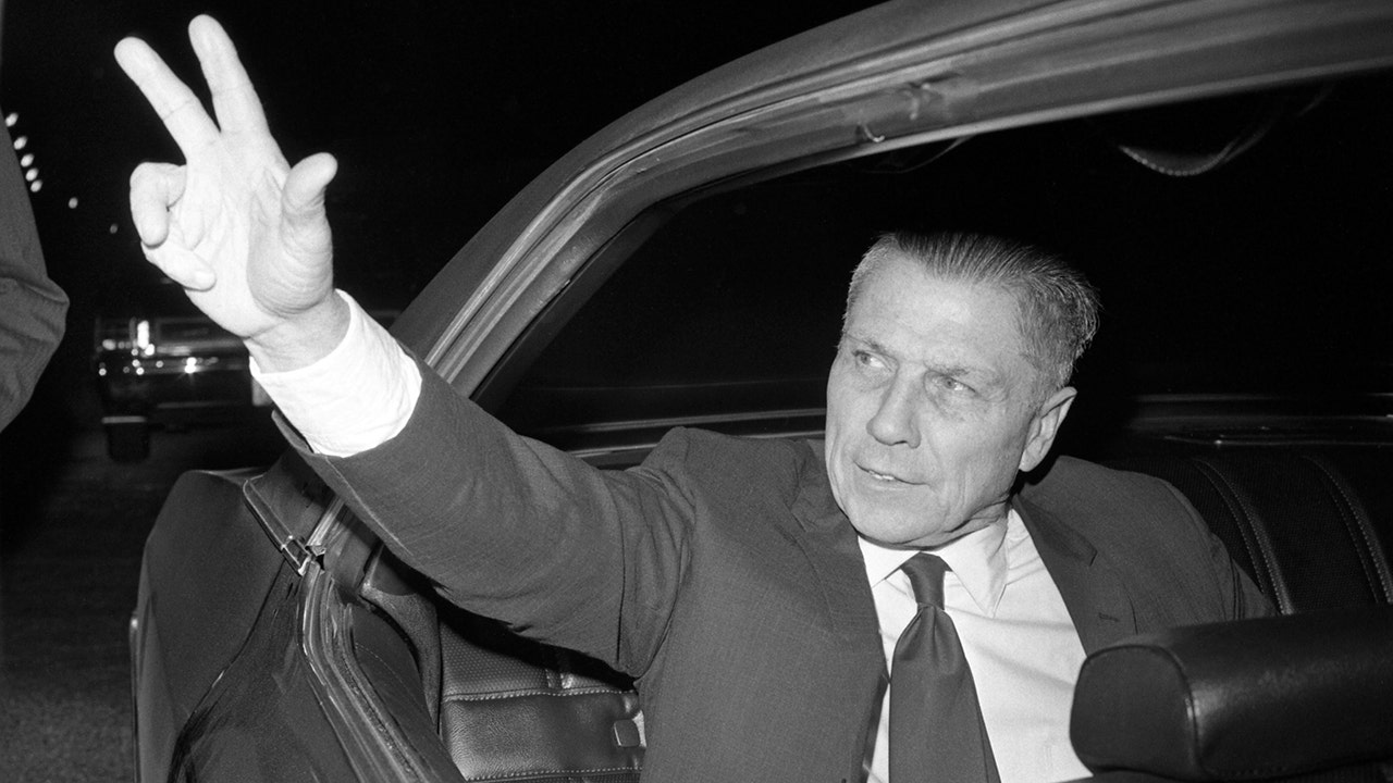 Jimmy Hoffa waving from a car