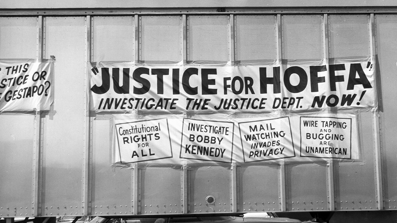 Signs on the side of a truck calling for justice for Jimmy Hoffa