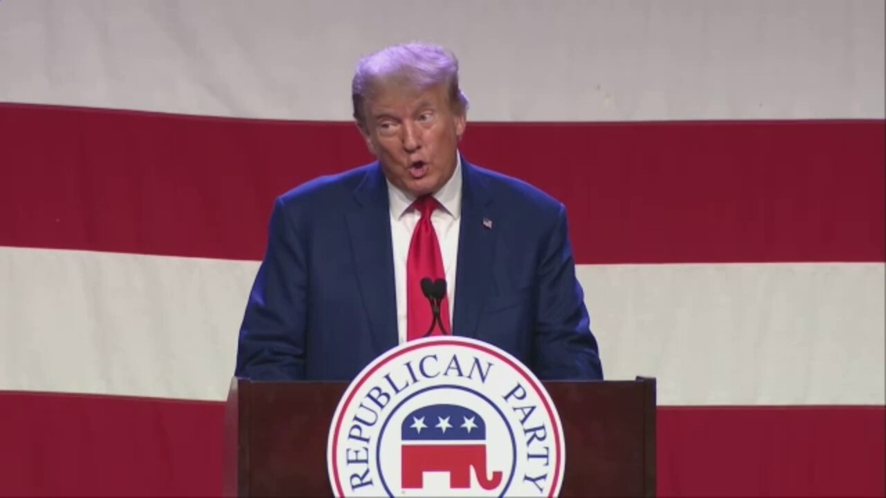 Trump bounds onto stage during Iowa GOP dinner while song lyrics about 'going to prison' plays