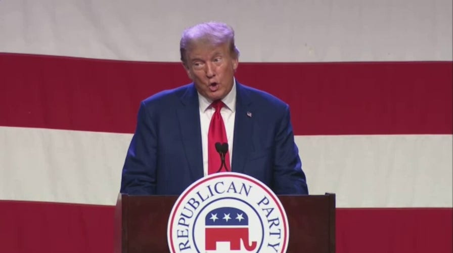Trump bounds onto stage during Iowa GOP dinner while song lyrics about 'going to prison' plays