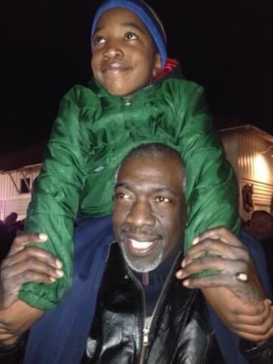 Solomon Wynn sits on his father's shoulders