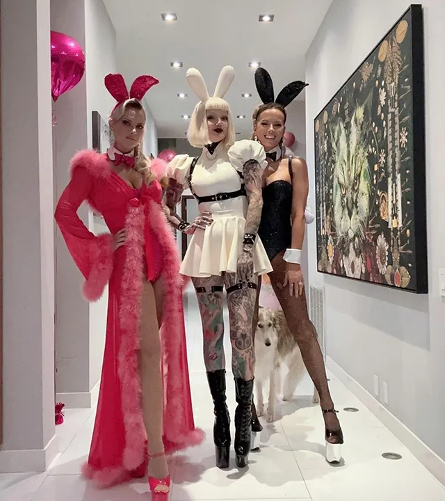 Kate Beckinsale in her "Playboy" bunny outfit stands behind two friends in similar attire