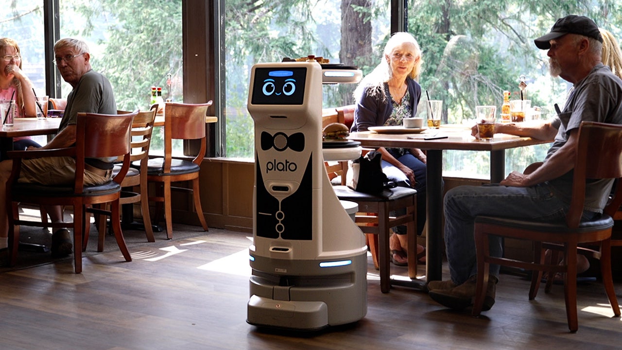 Robot serves diners lunch inside restaurant