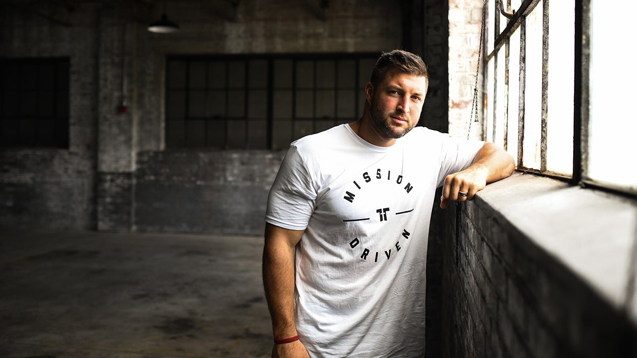 Tim Tebow wearing a "Mission Driven" T-shirt